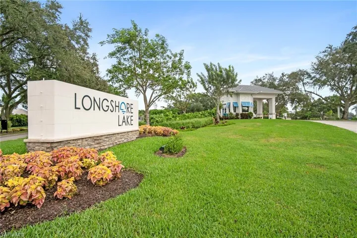 Community / neighborhood sign featuring a yard