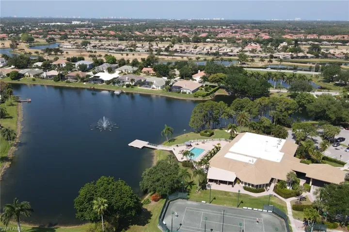 Aerial view of property's location with a nearby body of water and nearby suburban area