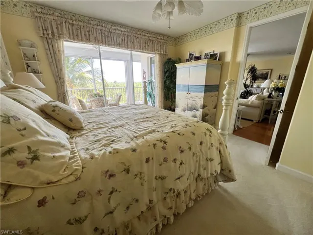 Master Bedroom with light carpet, ceiling fan and baseboards