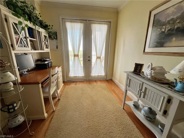 Breakfast Nook or Office featuring French Doors to Lanai, light wood flooring, and crown moldings