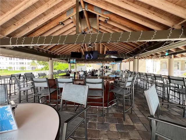 Tiki bar restaurant featuring an outdoor bar, gazebo type roof, and great food