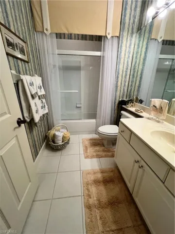 Bathroom off of 2nd Bedroom, with vanity, tile flooring, and tub/shower combination