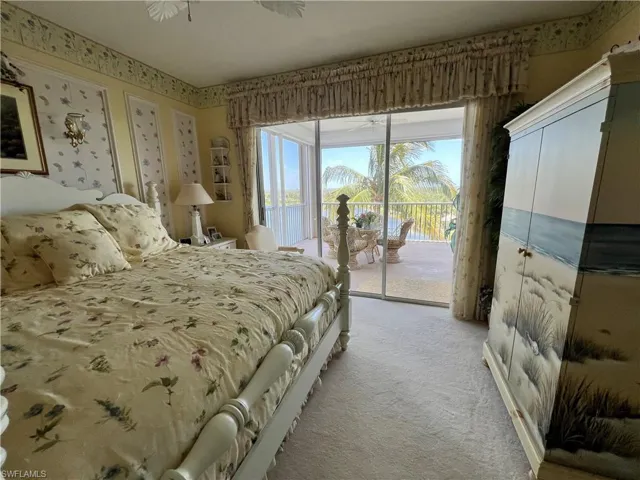 Master Bedroom with light carpet and access to Lanai