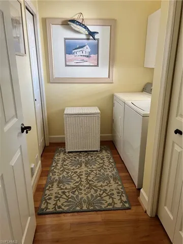 Laundry Room featuring washer and dryer and wood finished floors