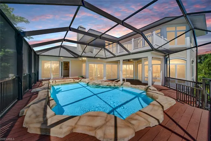 Pool at dusk featuring a lanai