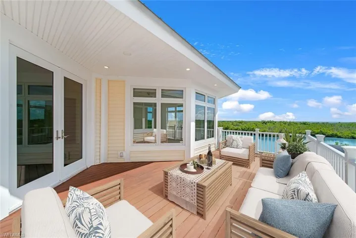 Wooden terrace with outdoor lounge area and french doors