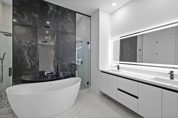 Bathroom with vanity and shower with separate bathtub