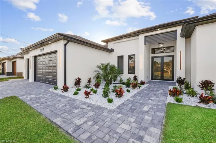 View of front of property featuring a garage and french doors