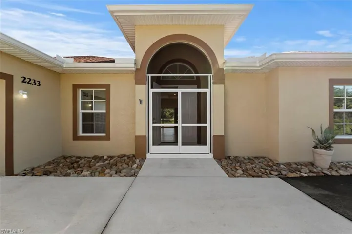 Arched entryway with a screened double-door entry