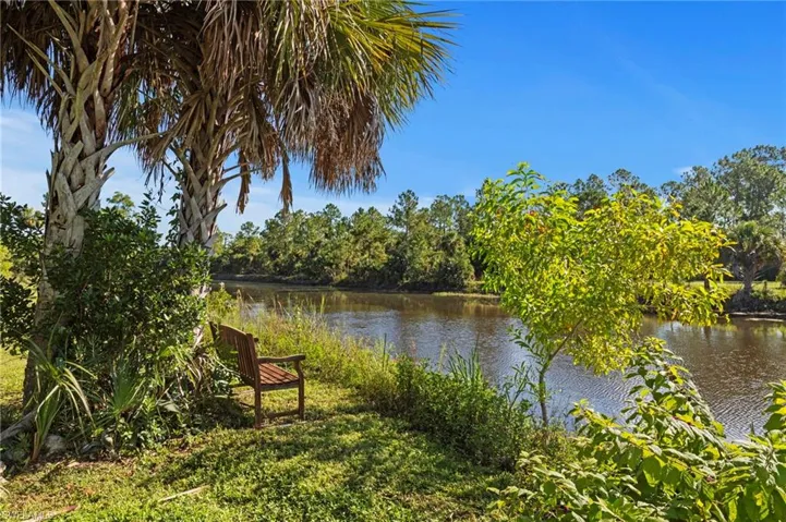 Lush landscaping with mature palm trees, offering a tranquil waterside setting