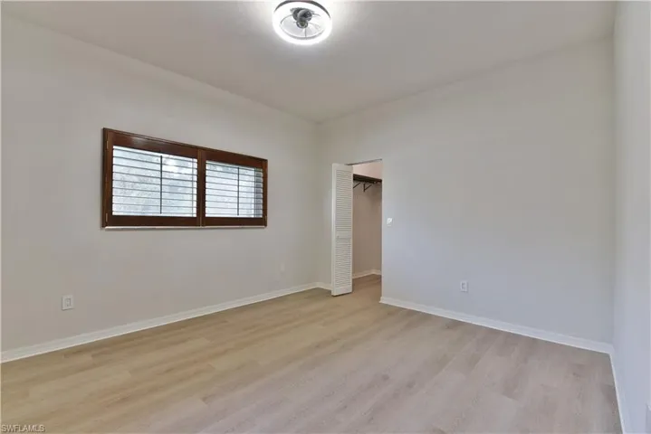 Spare room with light wood-style flooring and baseboards
