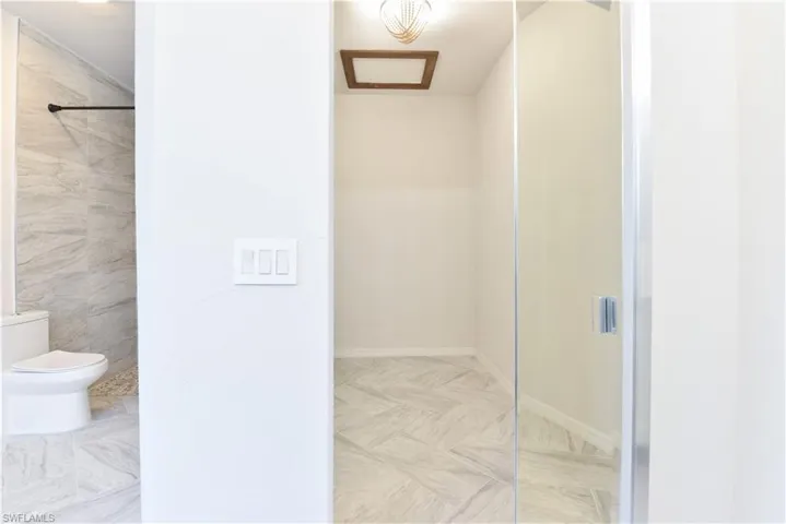 Full bathroom featuring toilet, baseboards, and walk in shower