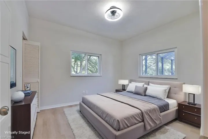 Bedroom featuring light wood finished floors and multiple windows