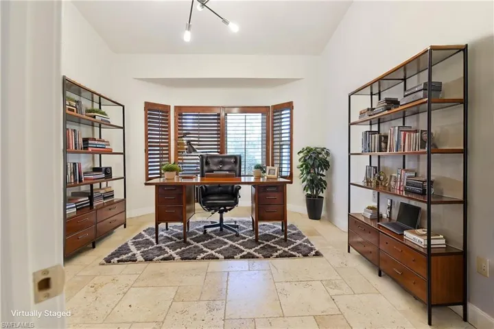 Office space featuring baseboards and stone tile floors