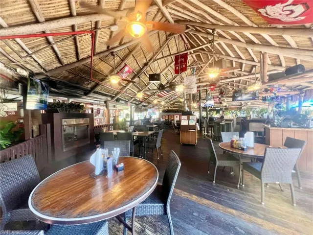 Dining space with hardwood / wood-style flooring and lofted ceiling with beams