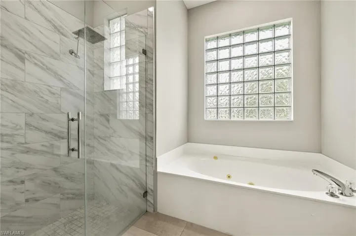 Full bathroom with a shower and a tub with jets