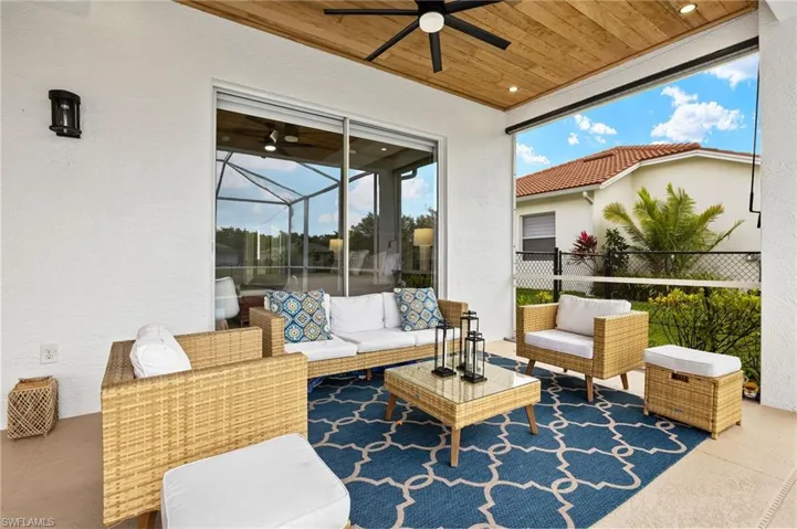 View of patio with ceiling fan, an outdoor living space, and fence