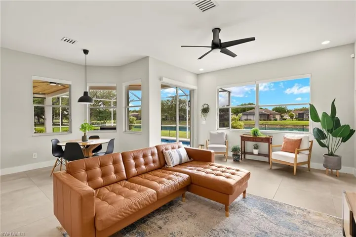 Living area with a ceiling fan, recessed lighting, visible vents, and 6in baseboards throughout.