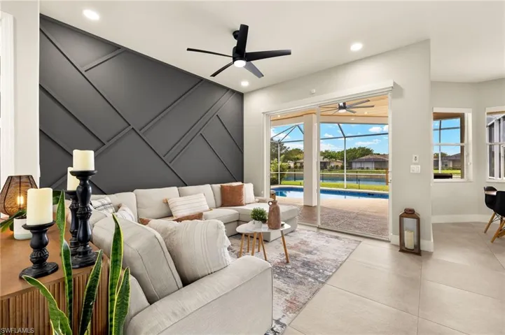 Living room with recessed lighting, a sunroom, plenty of natural light, and beautiful artistic walls.
