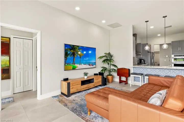 Living area with baseboards, visible vents, and recessed lighting.