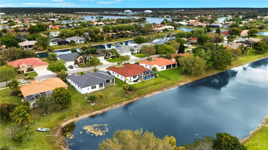 Birds eye view of property with a residential view and a water view