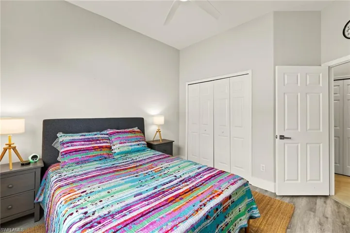 Bedroom with a closet, ceiling fan, and wood finished floors