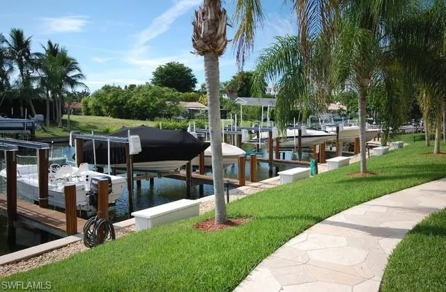 View of dock featuring a water view and a yard