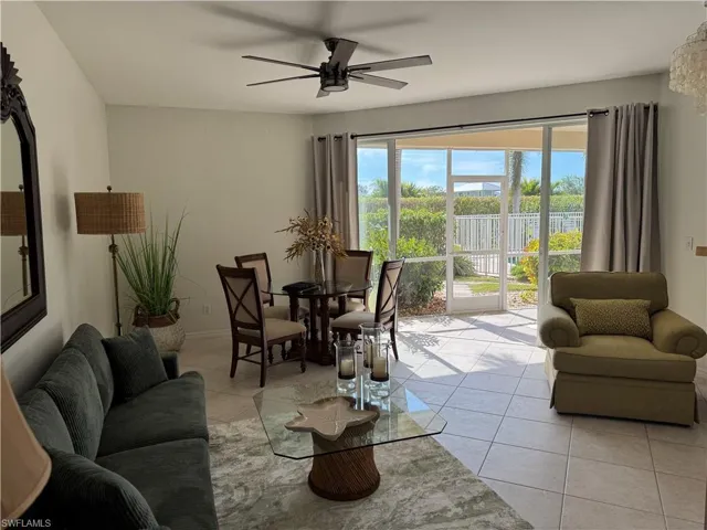 Living room featuring ceiling fan and light tile patterned flooring