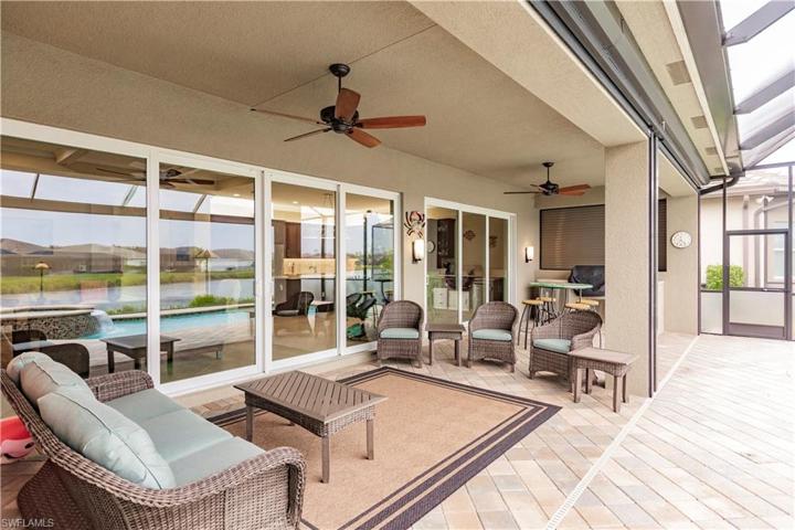 Expanded covered lanai for protection from the sun and elements.  Here you will find auto roll down Storm Smart style shutters to shield you from the afternoon sun or to easily store your pool "stuff" when away or when preparing for a storm.  In the winter we drop these hurricane rated screens to hold in the heat on those cool winter evenings.  Your living space just got bigger!