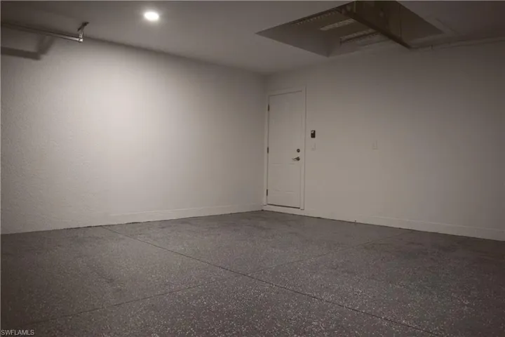 Garage featuring recessed lighting and baseboards