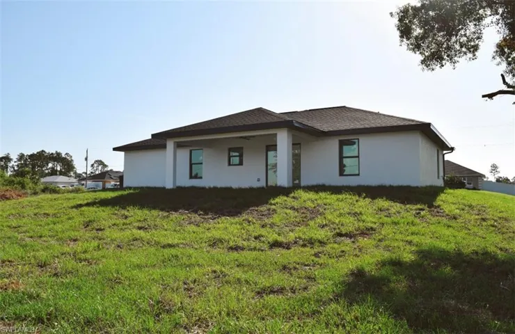 Prairie-style home featuring stucco siding and a front yard