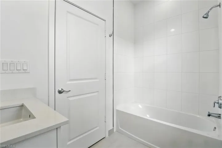 Bathroom with shower / bath combination and vanity
