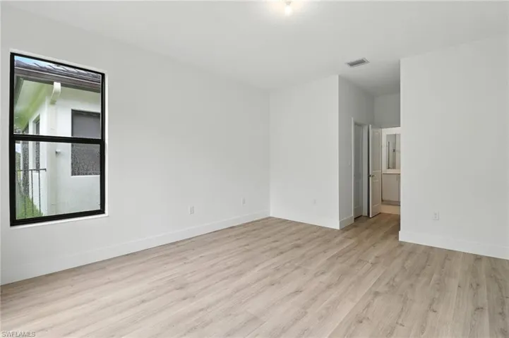 Empty room with wood finished floors and baseboards