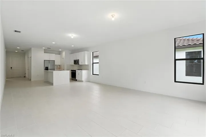 Unfurnished living room with a sink and recessed lighting