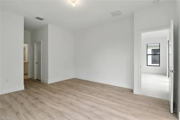 Unfurnished room featuring light wood-style floors and baseboards