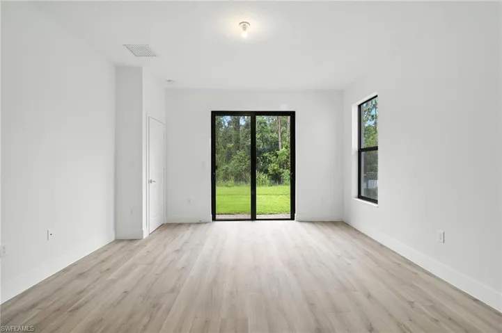 Unfurnished room featuring light wood-style floors and plenty of natural light
