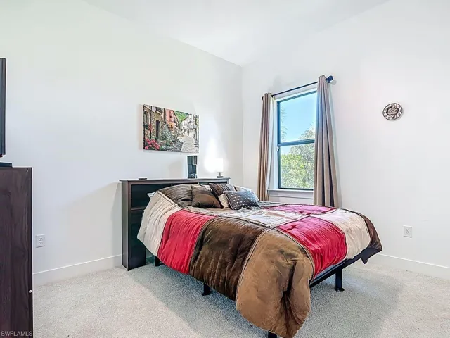 Carpeted bedroom featuring baseboards