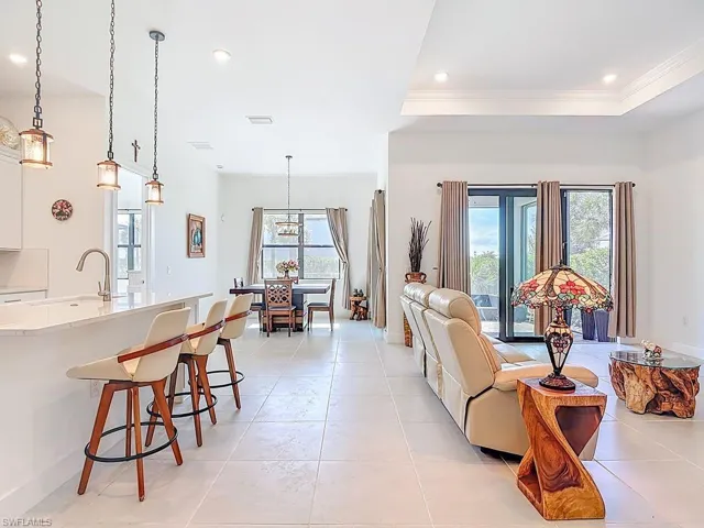 Living area featuring light tile patterned flooring, recessed lighting, and healthy amount of natural light