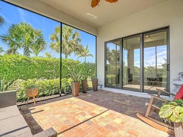 Unfurnished sunroom with brick flooring