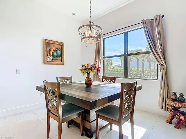 Dining room with a chandelier and light tile patterned floors
