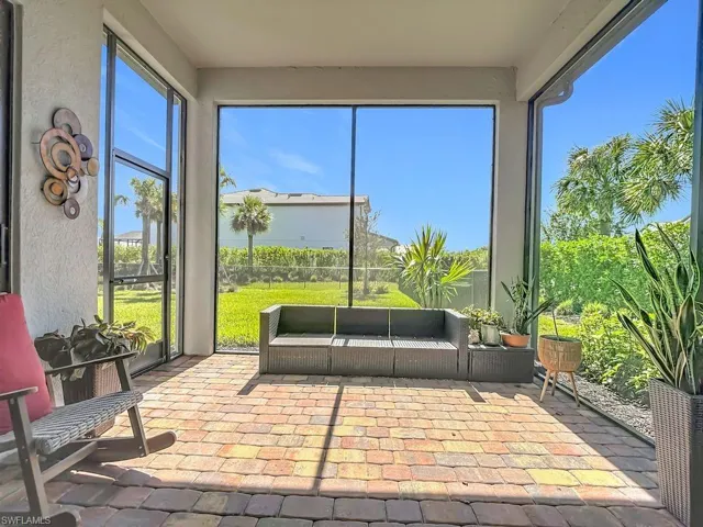 Sunroom featuring a patio