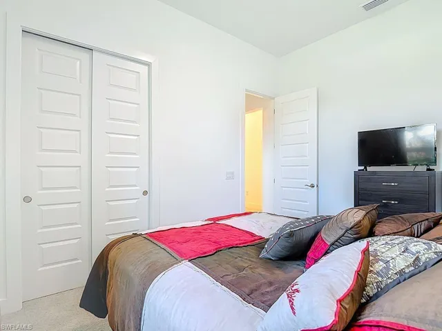 Bedroom with a closet and carpet floors