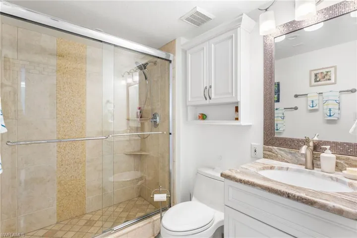 Renovated guest bathroom with custom shower, new vanity, lighting/plumbing fixtures.