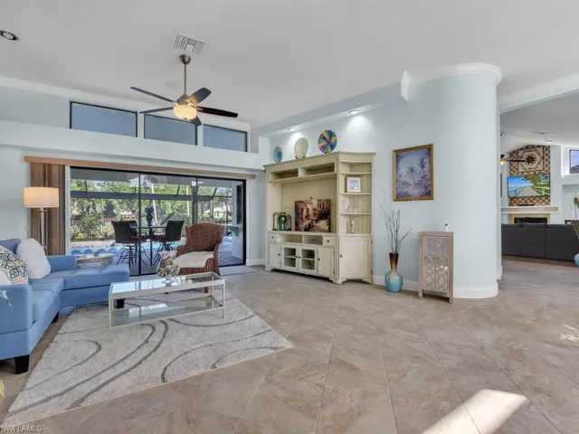 Living room with ceiling fan, baseboards, ornamental molding, and visible vents