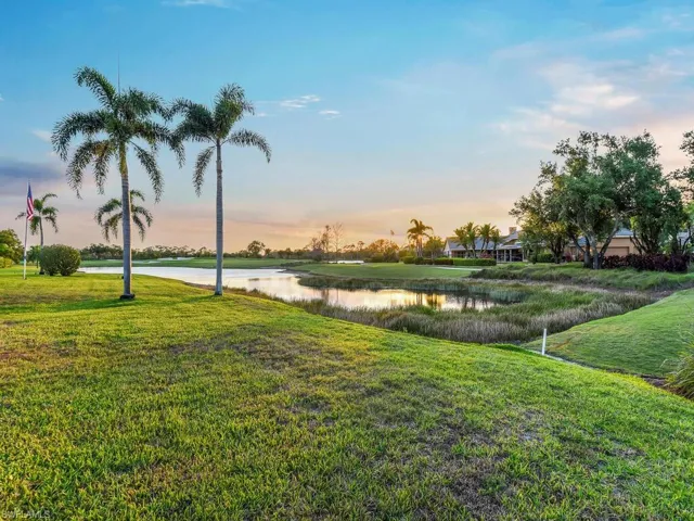 View of home's community with a lawn and a water view
