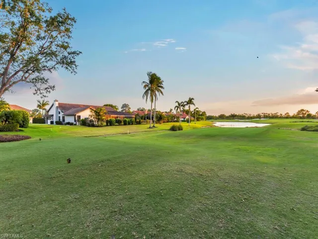 View of property's community with a lawn