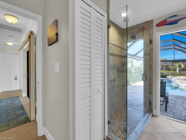 Bathroom featuring a shower stall, tile patterned floors, and visible vents