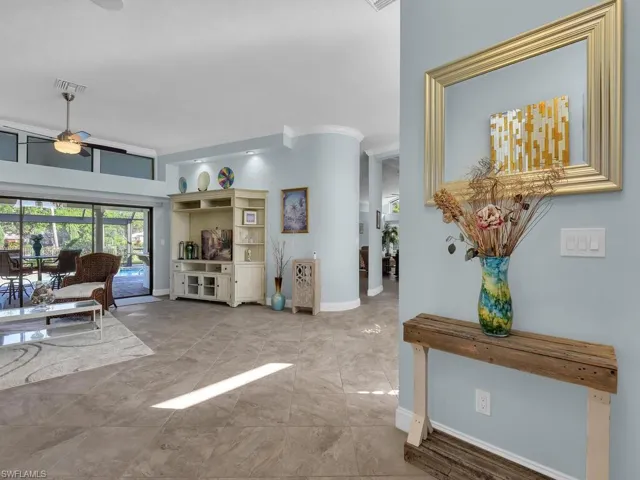 Living room featuring baseboards, a ceiling fan, and visible vents