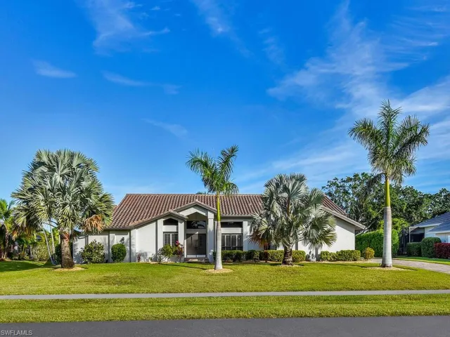 Mediterranean / spanish house with a tiled roof, a front lawn, and stucco siding