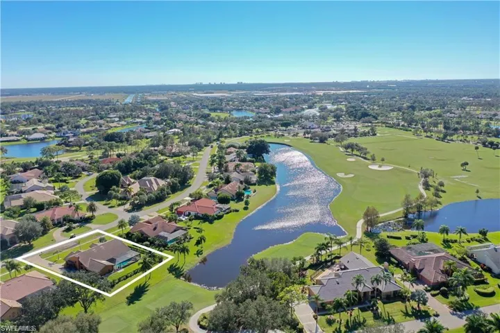 Aerial view with a water view, golf course view, and a residential view
